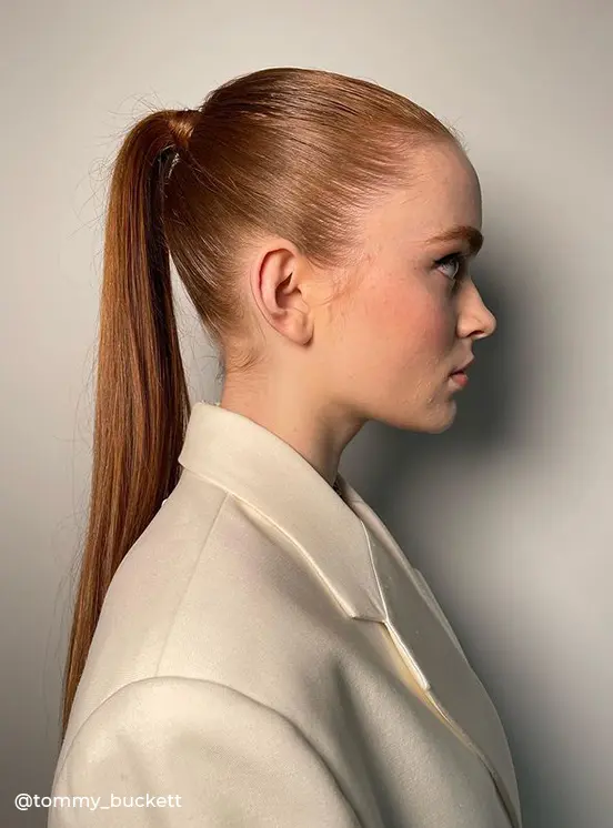 Girl with auburn hair color wearing a sleek high ponytail